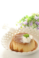 homemade custard pudding with flower on blackground