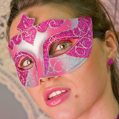 masked woman looking at camera