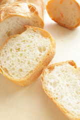 french bread, sliced baguette on wooden table