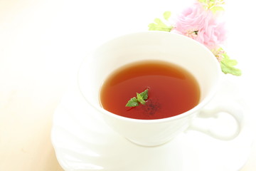 english mint black tea with flower on white background