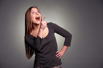 amazed woman laughing and pointing up
