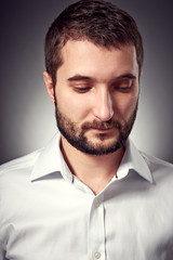 handsome man with beard looking down