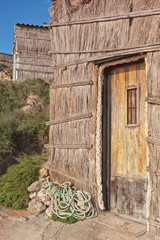 The doors of the old fisherman's house on the beach. Portugal, S