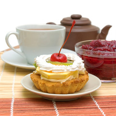 fruit cake against a cup of tea and jam
