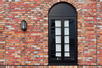 Black window on a brick wall