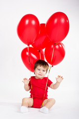 Fototapeta na wymiar Little baby boy with red balloons. Valentines day