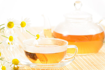 teapot and cup with camomile tea