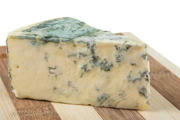 Wedge of soft blue cheese, isolated on white