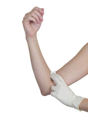 Hand pressing gauze on arm after administering an injection.