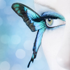beautiful woman eye close up with butterfly wings