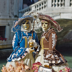 Person in Venetian costume attends Carnival of Venice.