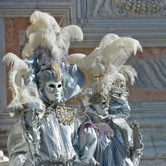 Person in Venetian costume attends Carnival of Venice.