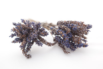 Two bunches of dried lavender on white