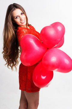 Valentines day woman holding red heart balloons
