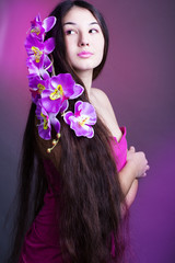 Fototapeta premium young beautiful girl with long hair and orchid