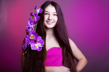 young beautiful girl with long hair and orchid