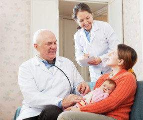 pediatrician doctor talks with mother of newborn baby