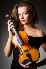 Woman performer with violin in studio