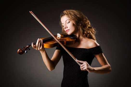 Woman performer with violin in studio