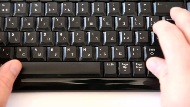 Male hands typing smth on a computer keyboard