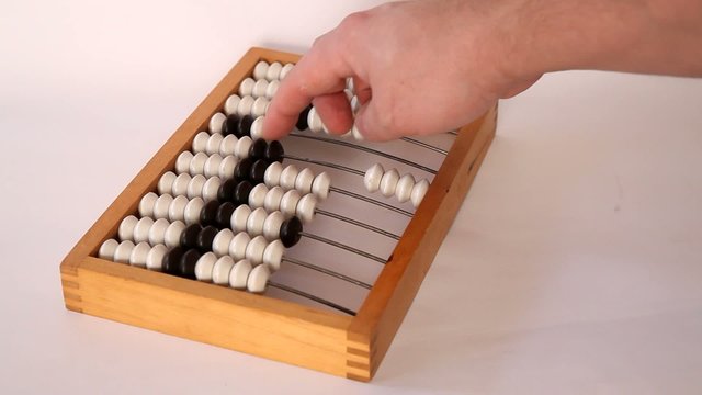 Male hand using the abacus to calculate basic algebra