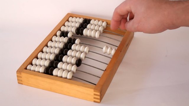 Male hand using the abacus to calculate basic algebra