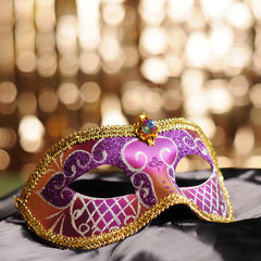 Carnival mask on black silk background