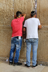 Jewish worshipers pray at the Wailing Wall. Jerusalem, Israel.