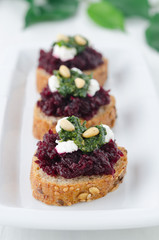 beet salad with pesto and goat cheese on toasted grain breads