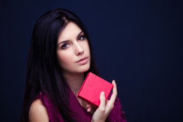 attractive young woman holding red gift box