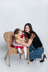 Beautiful little girl with mom on a white background