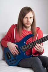 young guy playing guitar
