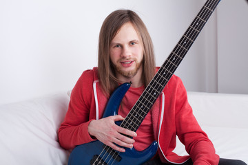 young guy playing guitar