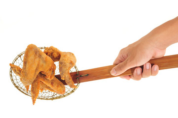 Scooping Up Fried Chicken Wings With A Kitchen Strainer