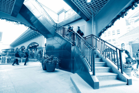 Low section of busy business people ascending on office stairs