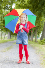 little girl with umbrella in alley