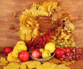 Autumnal composition with yellow leaves, apples and mushrooms