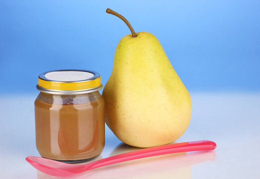 Useful and tasty baby food with pear and spoon