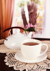 cup of tea with scarf on table in room