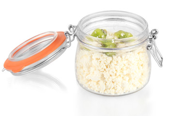Cottage cheese in glass bottle with kiwi fruit, isolated