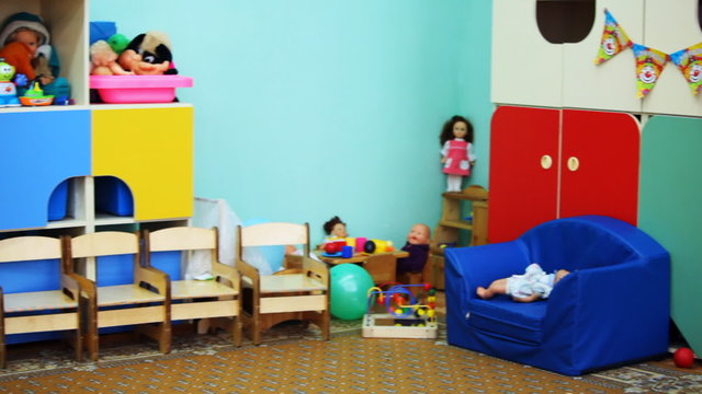 kindergarten room with colorful toys on shelves, panorama