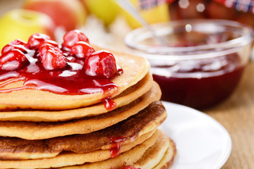 Delicious pancakes with raspberries on the wooden kitchen  tabl