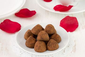 chocolate truffles on white plate and cup