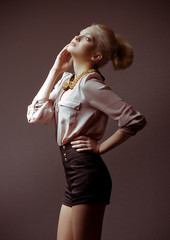 Portrait of beautiful young girl in fashion clothes