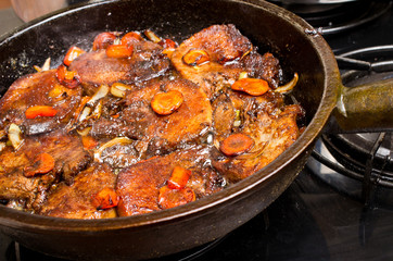 Steaks with vegetables on the pan