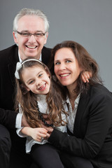 Happy family with father, mother and daughter. Studio shot.