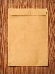 Envelope documents on vintage wood