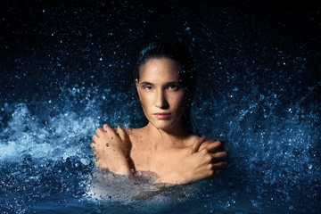 Beautiful woman in a spray of water