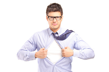 Young handsome man tearing off his shirt