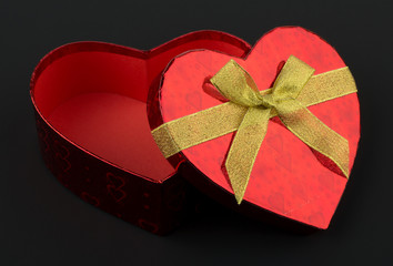 Heart shaped Valentines Day gift box on black background
